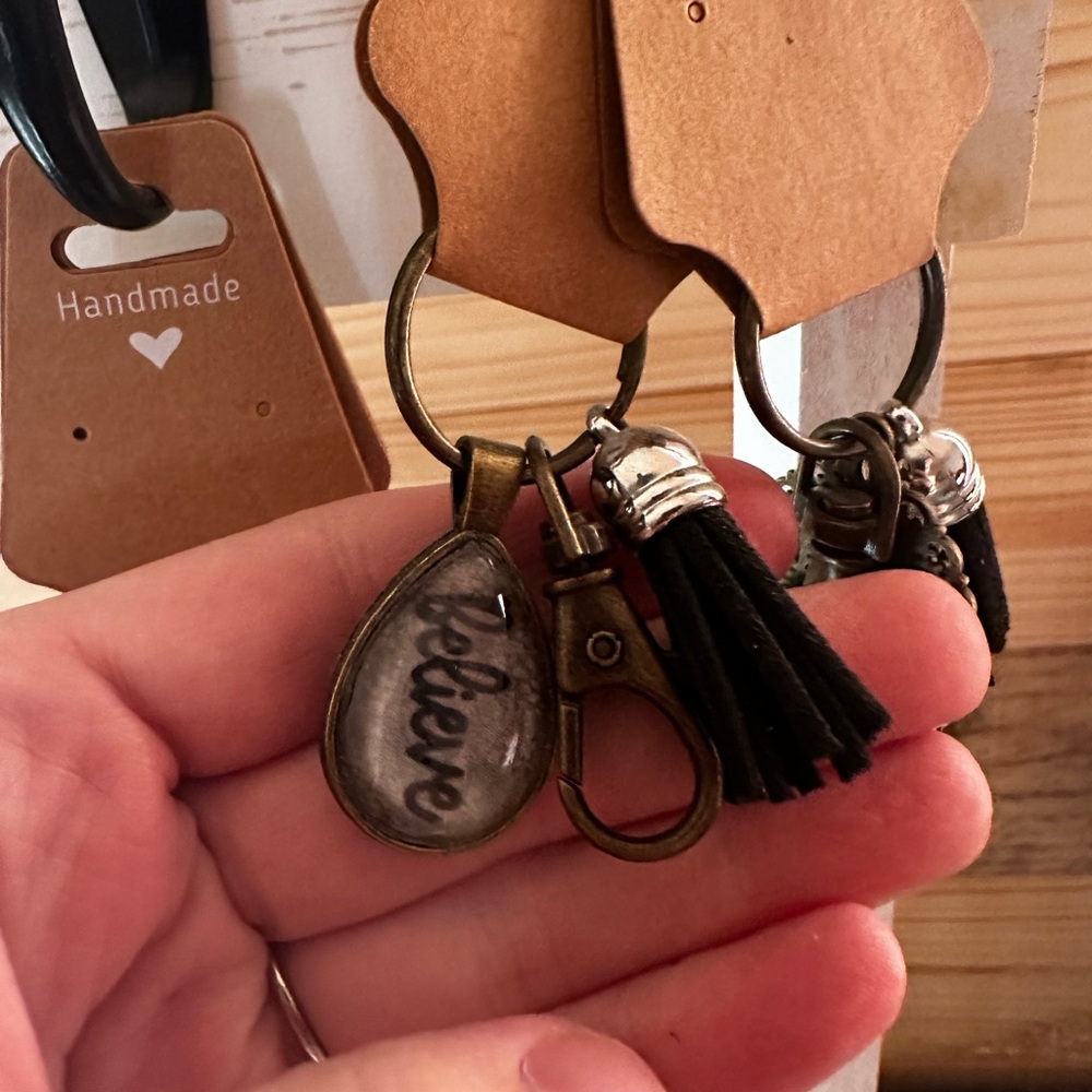 Bronze 'Believe' Keychain with Black Tassel